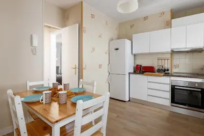 a kitchen with a wooden table and white appliances at Mercat Sant Antoni 4 in Barcelona