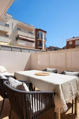 a white table and chairs on a balcony at Aparthotel Centric in Castelldefels