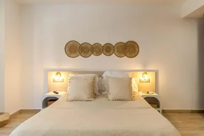 a bedroom with a large bed with two pillows at Aparthotel Centric in Castelldefels