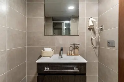 a bathroom with a sink and a mirror at Aparthotel Centric in Castelldefels