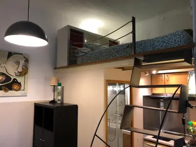 a small room with a bunk bed and a staircase at Estudio Finestrelles Barcelona in Esplugues de Llobregat