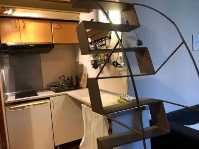 a kitchen with a spiral shelf in a kitchen at Estudio Finestrelles Barcelona in Esplugues de Llobregat