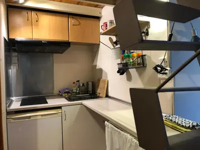a kitchen with white cabinets and a stove top oven at Estudio Finestrelles Barcelona in Esplugues de Llobregat