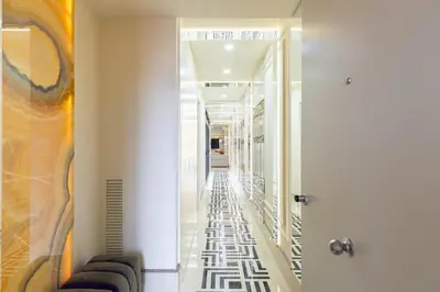 a corridor in a building with a painting on the wall at Cosmo Apartments Rambla Catalunya in Barcelona