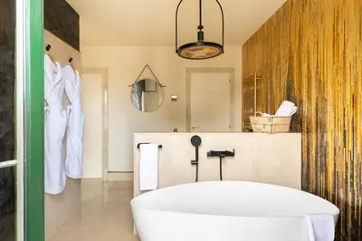 a bathroom with a white tub and a mirror at Cosmo Apartments Rambla Catalunya in Barcelona