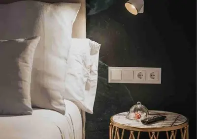 a bedroom with a bed and a table with a clock on it at Les Quingles in Calders