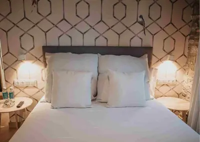 a bedroom with a bed with white pillows at Les Quingles in Calders