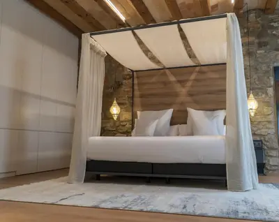 a bedroom with a bed with a canopy at Les Quingles in Calders