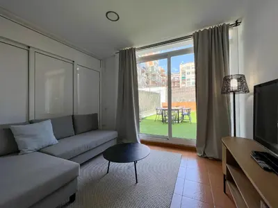 a living room with a couch and a large window at Stay U-nique Apartments Urgell in Barcelona