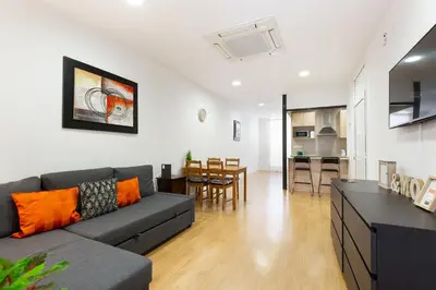 a living room with a couch and a dining room at Stay U-nique Apartments Urgell in Barcelona