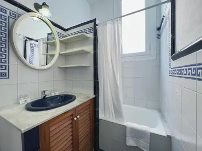 a bathroom with a sink and a mirror and a tub at Stay U-nique Apartments Rogent in Barcelona