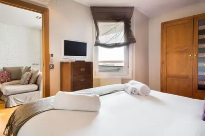 a bedroom with a bed with towels on it at Stay U-nique Apartments Sardenya in Barcelona