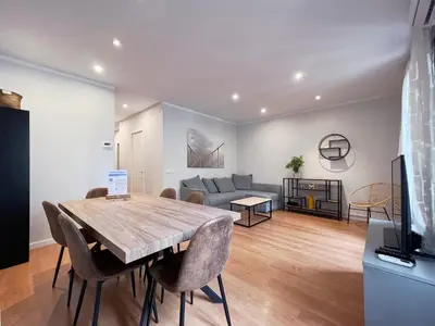 a living room with a table and a couch at Stay U-nique Apartments Travessera in Barcelona