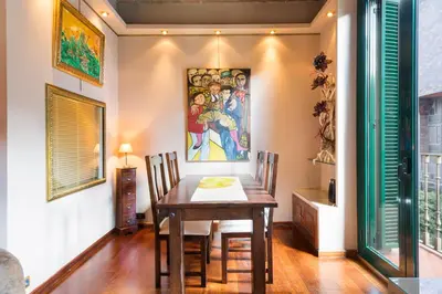 a dining room with a table and a painting on the wall at Stay U-nique Apartments Urquinaona in Barcelona