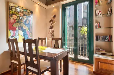 a dining room with a table and chairs and a window at Stay U-nique Apartments Urquinaona in Barcelona