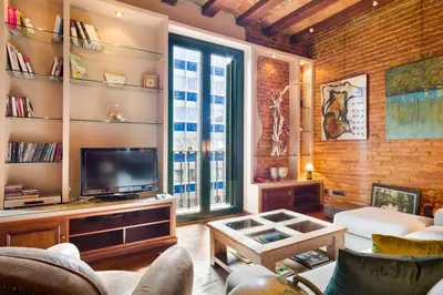 a living room with a couch and a tv at Stay U-nique Apartments Urquinaona in Barcelona
