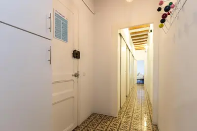 a hallway with a white door and a tile floor at Stay Unique Apartments Corsega in Barcelona