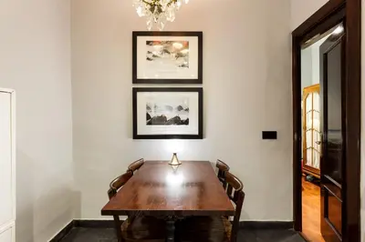 a dining room with a wooden table and pictures on the wall at Stay U-nique Apartments Obradors in Barcelona