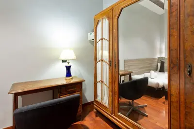 a mirror and a desk with a chair and a lamp at Stay U-nique Apartments Obradors in Barcelona