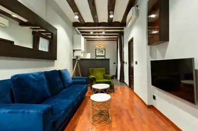 a living room with a blue couch and two chairs at Stay U-nique Apartments Obradors in Barcelona