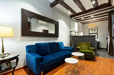 a living room with a blue couch and two chairs at Stay U-nique Apartments Obradors in Barcelona