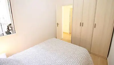 a white bedroom with a bed and a closet at Sagrada Familia Apartamento eco friendly in Barcelona