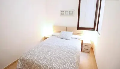 a small bedroom with a bed and a window at Sagrada Familia Apartamento eco friendly in Barcelona