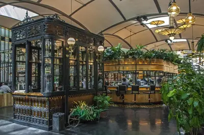 a bar in a building with a lot of bottles at Habitat Apartments Paseo de Gracia in Barcelona