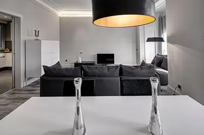 a living room with a table and a couch at Habitat Apartments Paseo de Gracia in Barcelona