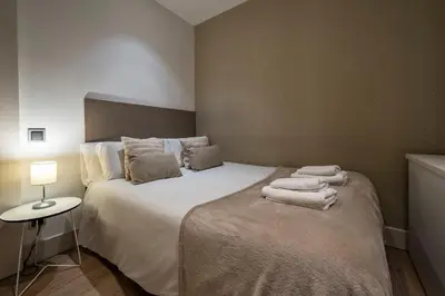 a bedroom with a bed with towels on it at Habitat Apartments Paseo de Gracia in Barcelona