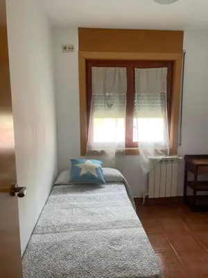 a small bedroom with a bed and a window at CASA la PAU in Vilassar de Mar