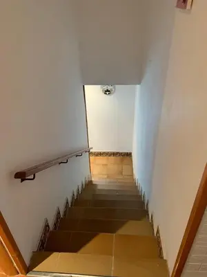 a staircase in a building with a white wall and a stair case at CASA la PAU in Vilassar de Mar
