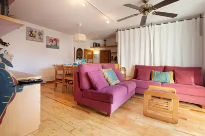 a living room with a purple couch and a table at Atic Gaudi-Gracia in Barcelona