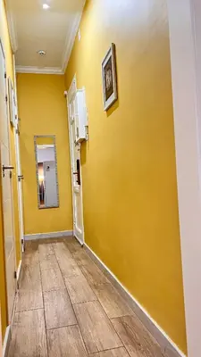 a hallway with a yellow wall and a mirror at New Camp Nou Apartment/Diret Airport,Beautiful in Hospitalet de Llobregat