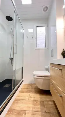 a bathroom with a toilet and a glass shower at New Camp Nou Apartment/Diret Airport,Beautiful in Hospitalet de Llobregat