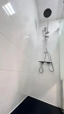a white bathroom with a shower with a microphone at New Camp Nou Apartment/Diret Airport,Beautiful in Hospitalet de Llobregat