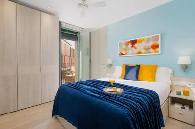 a bedroom with a bed with a tray on it at Kronos on the beach Suite 2 in Barcelona