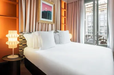 a large white bed in a room with a window at One Shot Aragó in Barcelona