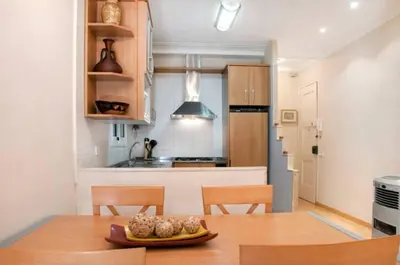 a kitchen with a table with a plate of food on it at Bbarcelonapartment Acogedor, tranquilo con Balcón in Barcelona