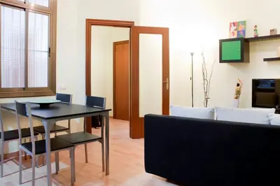 a living room with a table and a couch at Apartamento Cerca del Mar in Badalona