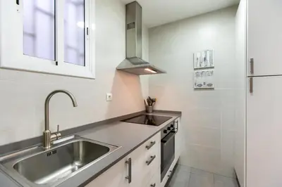 a kitchen with a sink and a stove at Pere Serafi 2 bedroom apartment in Barcelona