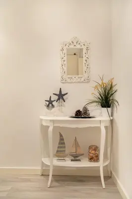 a white console table with a mirror and starfish at Pere Serafi 2 bedroom apartment in Barcelona