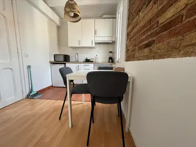 a kitchen with a table and chairs in a room at Ático ideal en Barcelona in Barcelona