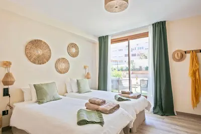 two beds in a room with a window at Olivia Barcelona in Barcelona