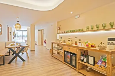 a kitchen with a table and a counter with wine bottles at Olivia Barcelona in Barcelona