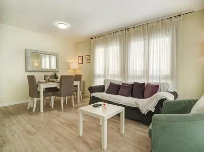 a living room with a couch and a table at Beach Matucana Apartment by Hello Homes Sitges in Sitges