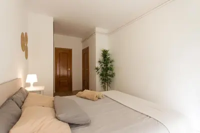 a white bedroom with a large bed in it at INNOUTHOME Apartamento Eixample Barcelona in Barcelona