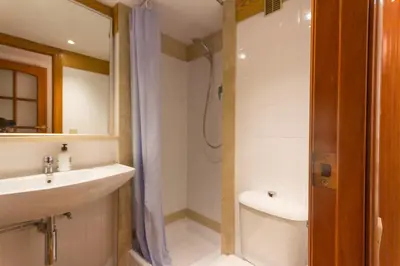 a bathroom with a sink and a toilet and a shower at INNOUTHOME Apartamento Eixample Barcelona in Barcelona