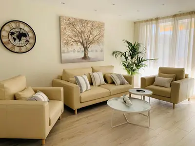 a living room with a couch and a table at Sitges Spaces Oasis Suites- 4 Bedroom, 4 Ensuite Bathrooms, Terrace, Pool, Sitges Centre in Sitges