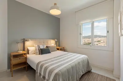 a bedroom with a large bed and a window at Click&Flat Luxury Tetuan in Barcelona